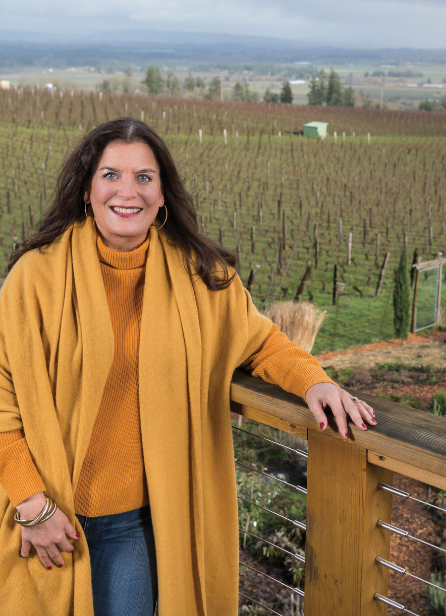 Janie Brooks Heuck in front of the vineyard