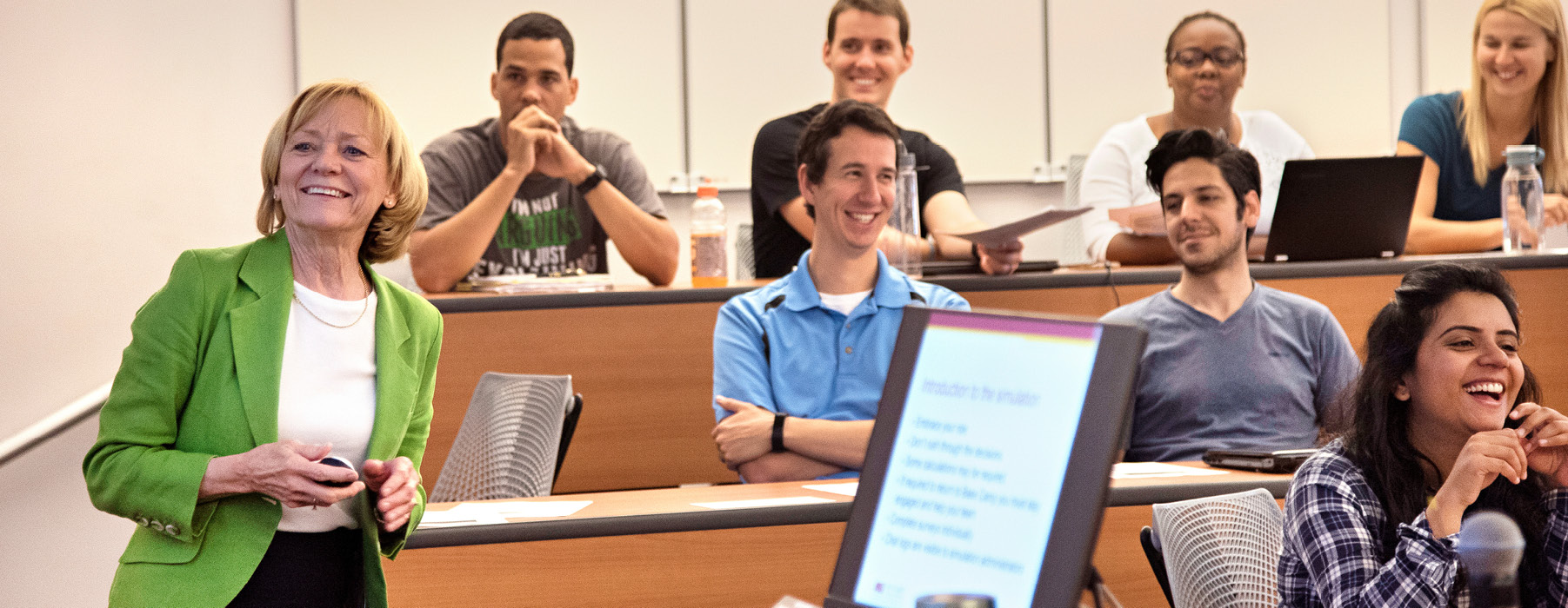 professor smiling along with the students in her classroom