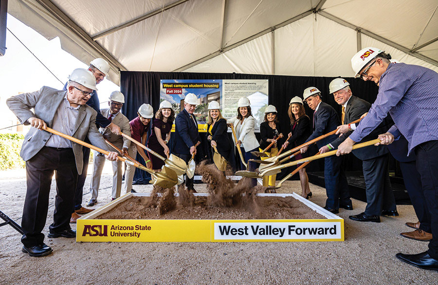 business people in hard hats conducting a ceremonial first dig