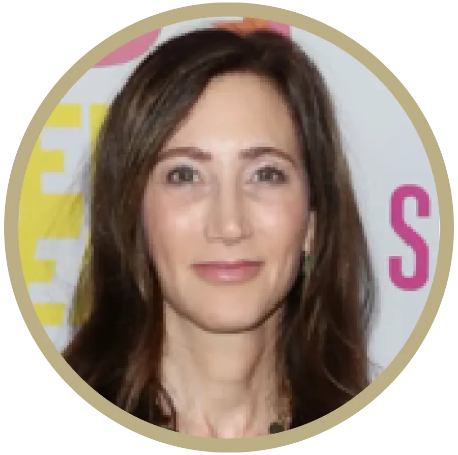 Beige color outer circular icon displaying a portrait photo headshot of Nancy Shevell McCartney grinning