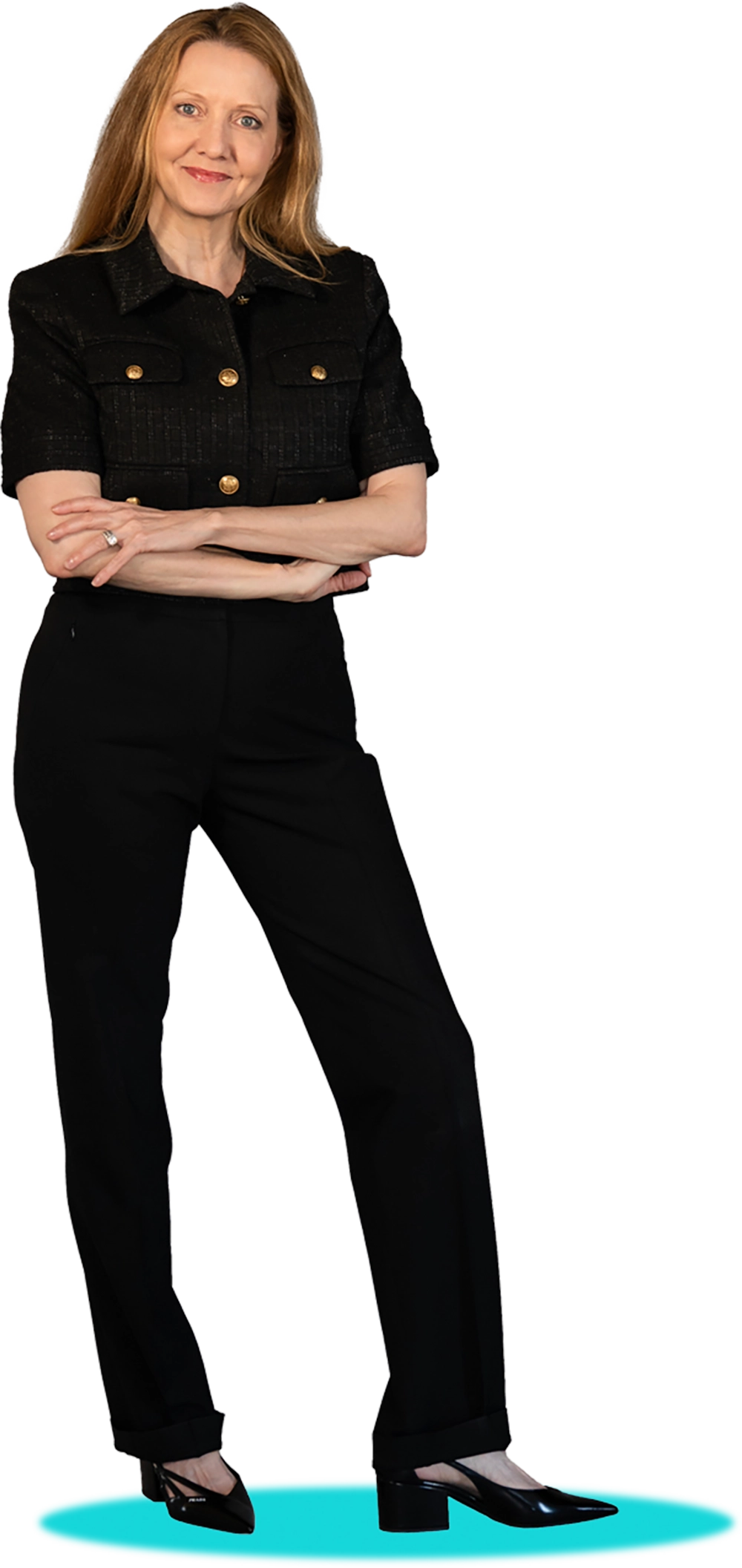 Professional woman in a black jacket and pants, arms crossed.