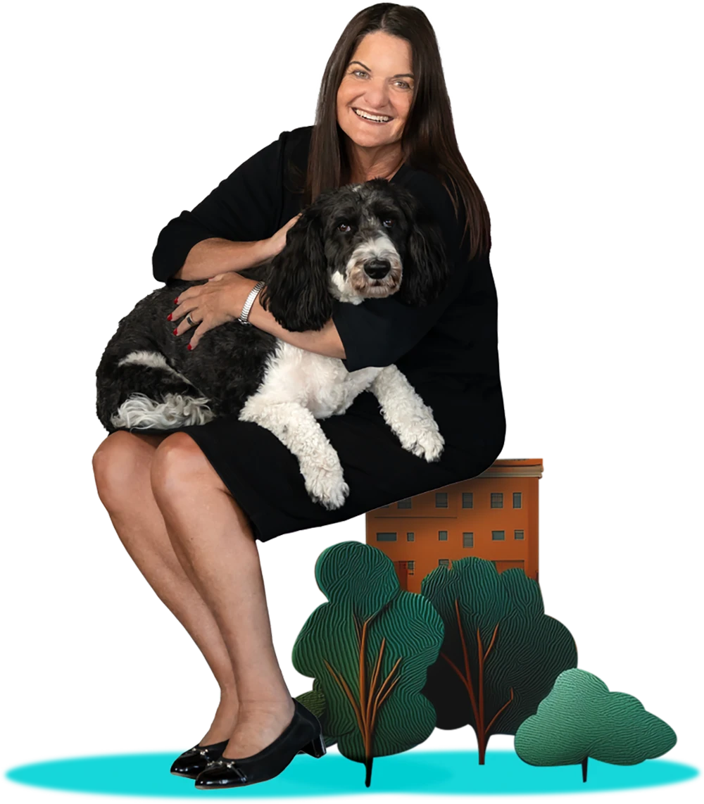 Smiling woman in a black dress sits, holding a black and white dog on her lap.
