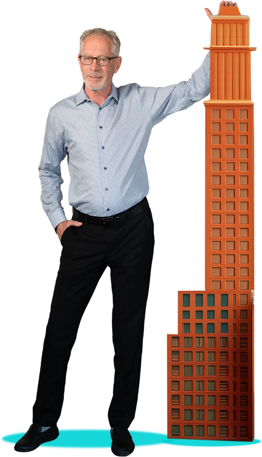 Man in a light blue patterned shirt leaning on a tall, orange model skyscraper.